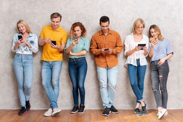 Teens with phones - write your sms message for your target audience